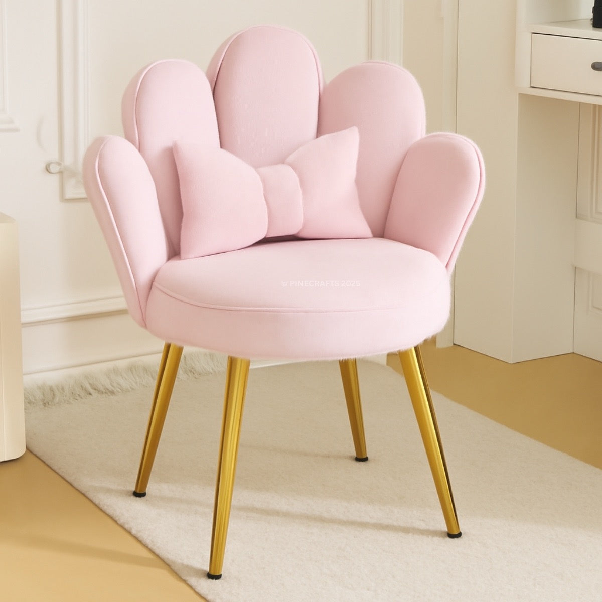 Pink chair with gold legs in a room setting