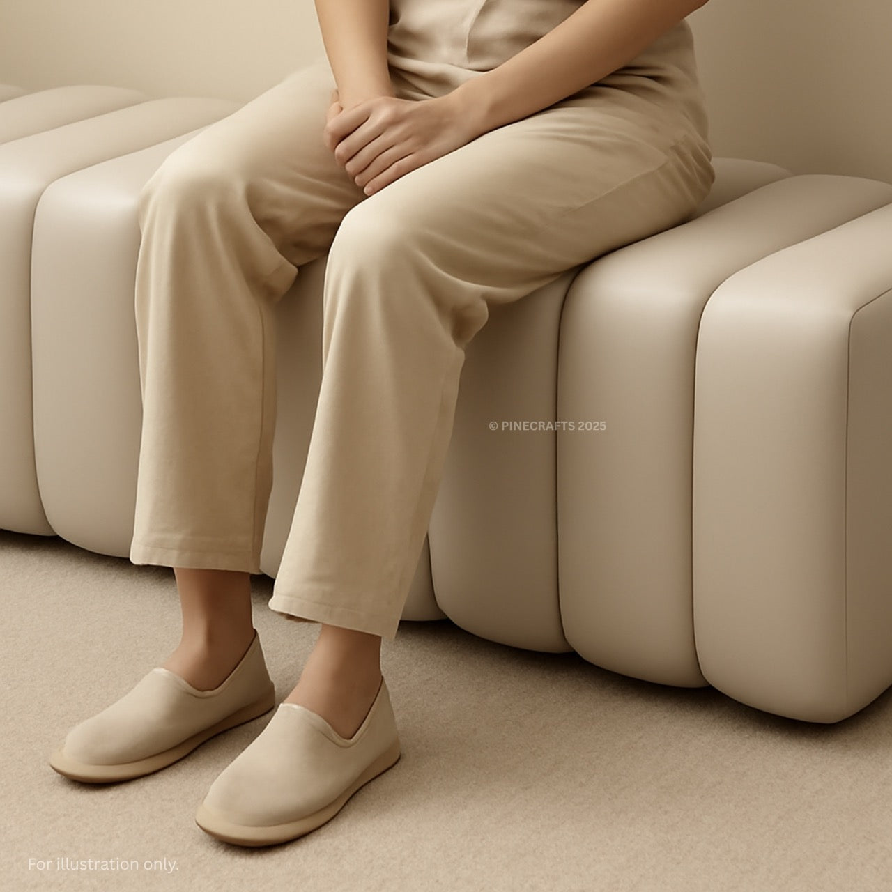 Person wearing beige shoes sitting on a beige sofa.