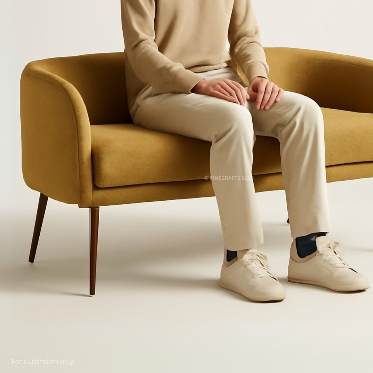 Person sitting on a mustard yellow chair wearing beige pants and shoes.