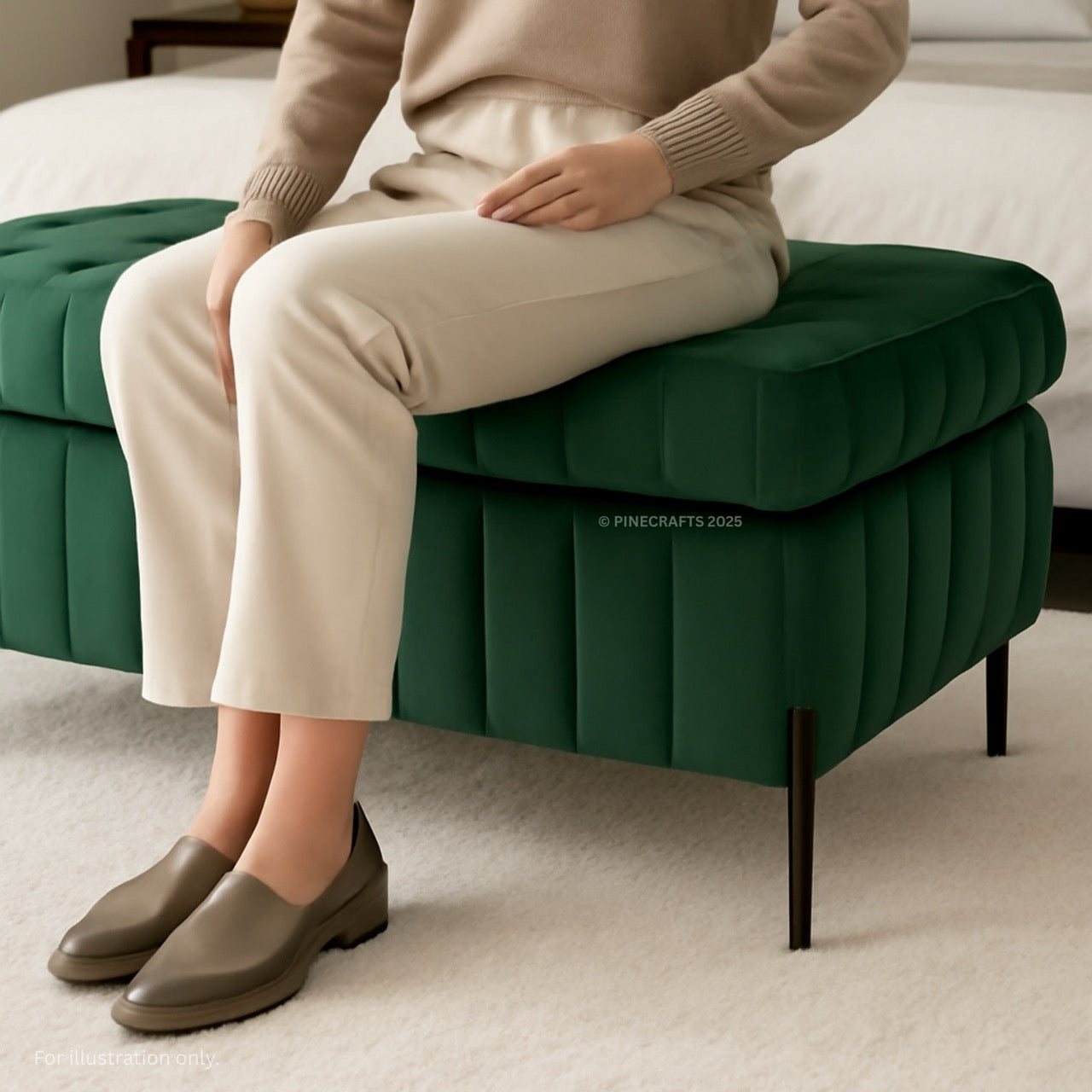 Person sitting on a green ottoman wearing beige pants and shoes in a room.