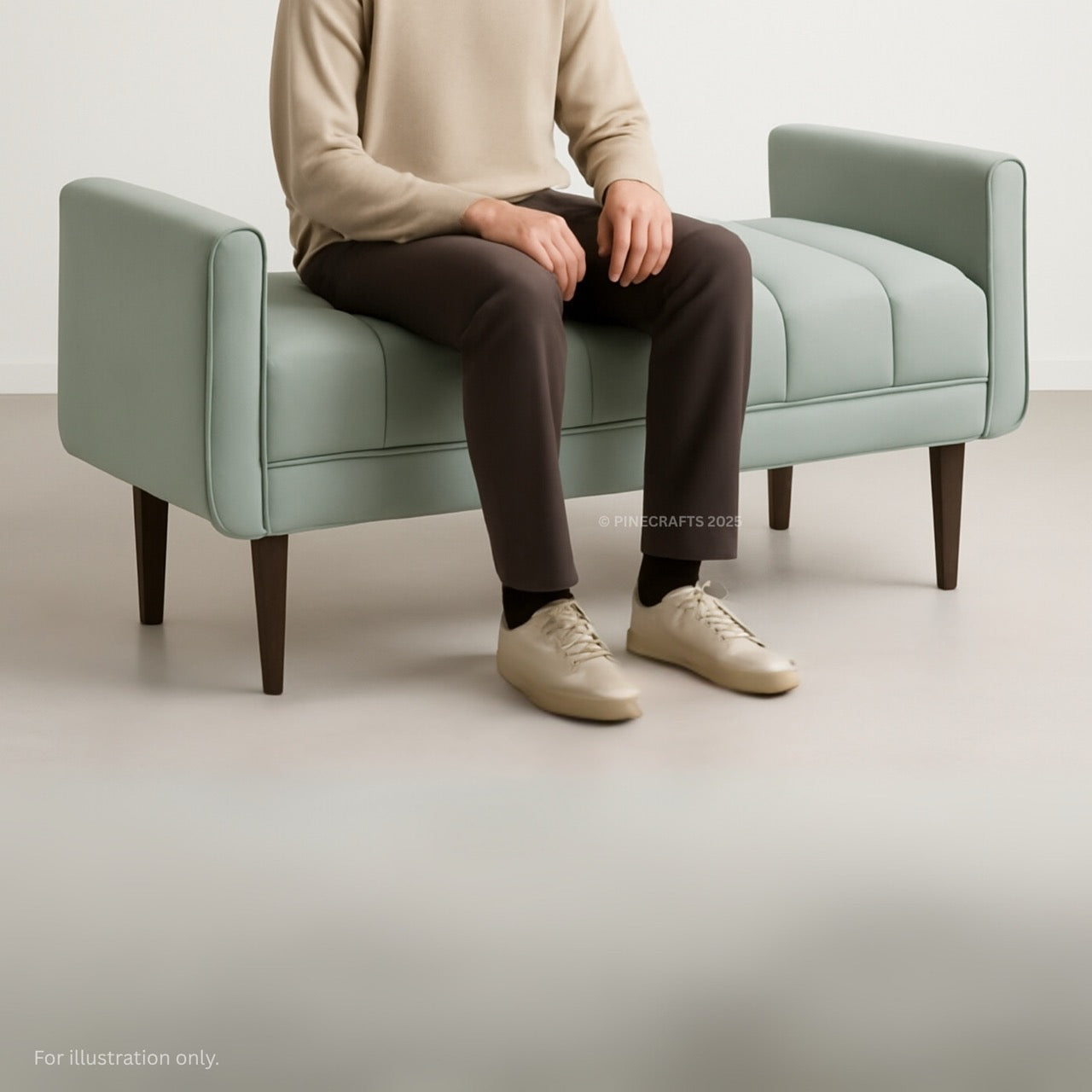 Person sitting on a light green bench with a neutral background