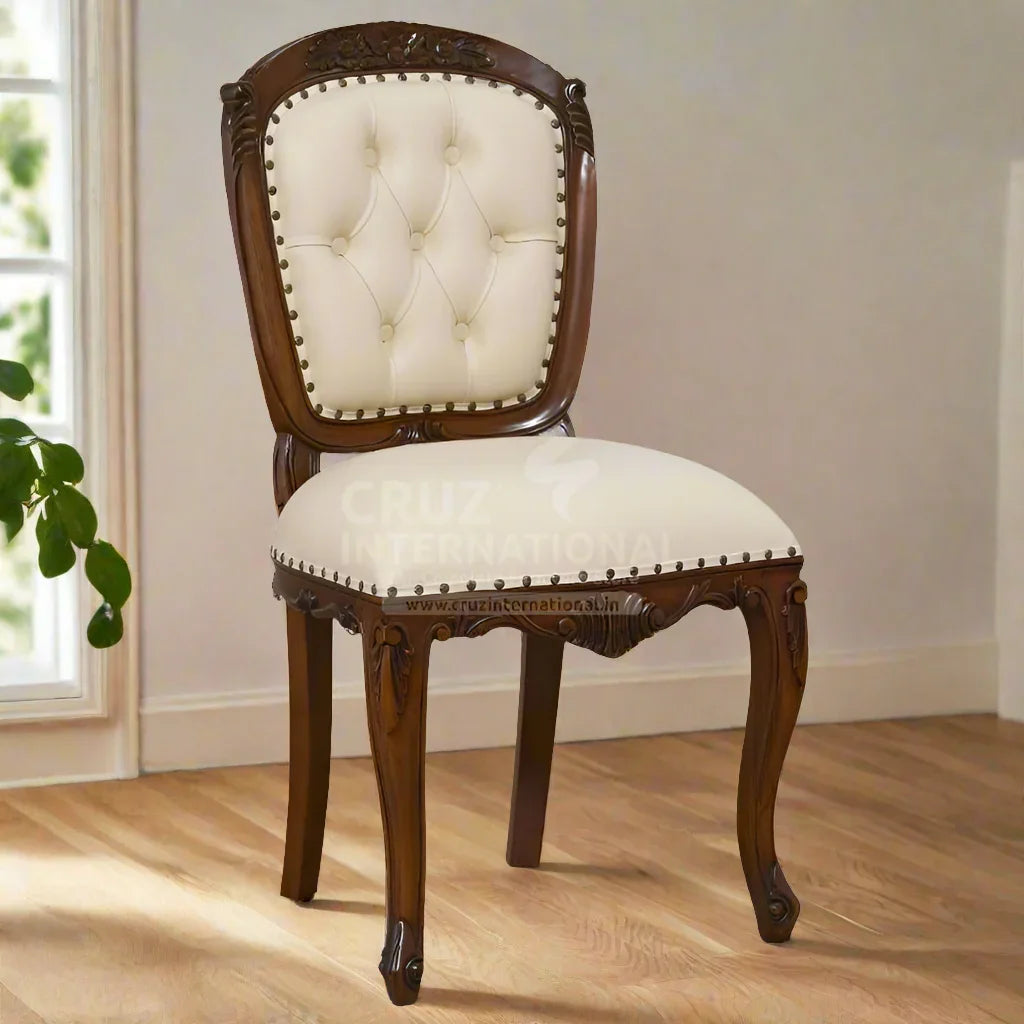 A traditional dining chair with a tufted backrest and a round, upholstered seat cushion in a carved wooden frame on a hardwood floor.