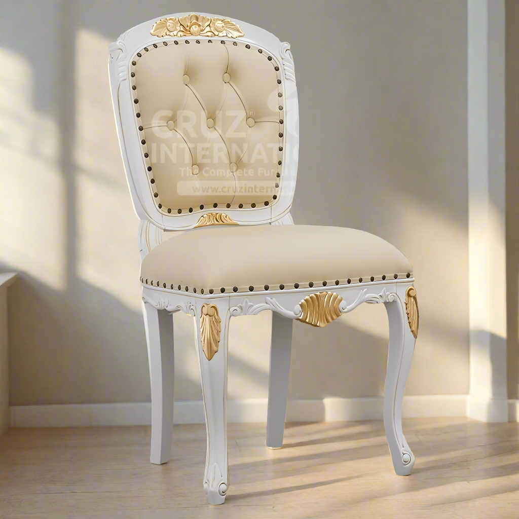 A white and gold classic dinning chair with upholstered seat and backrest, featuring carved details and tufted buttons.