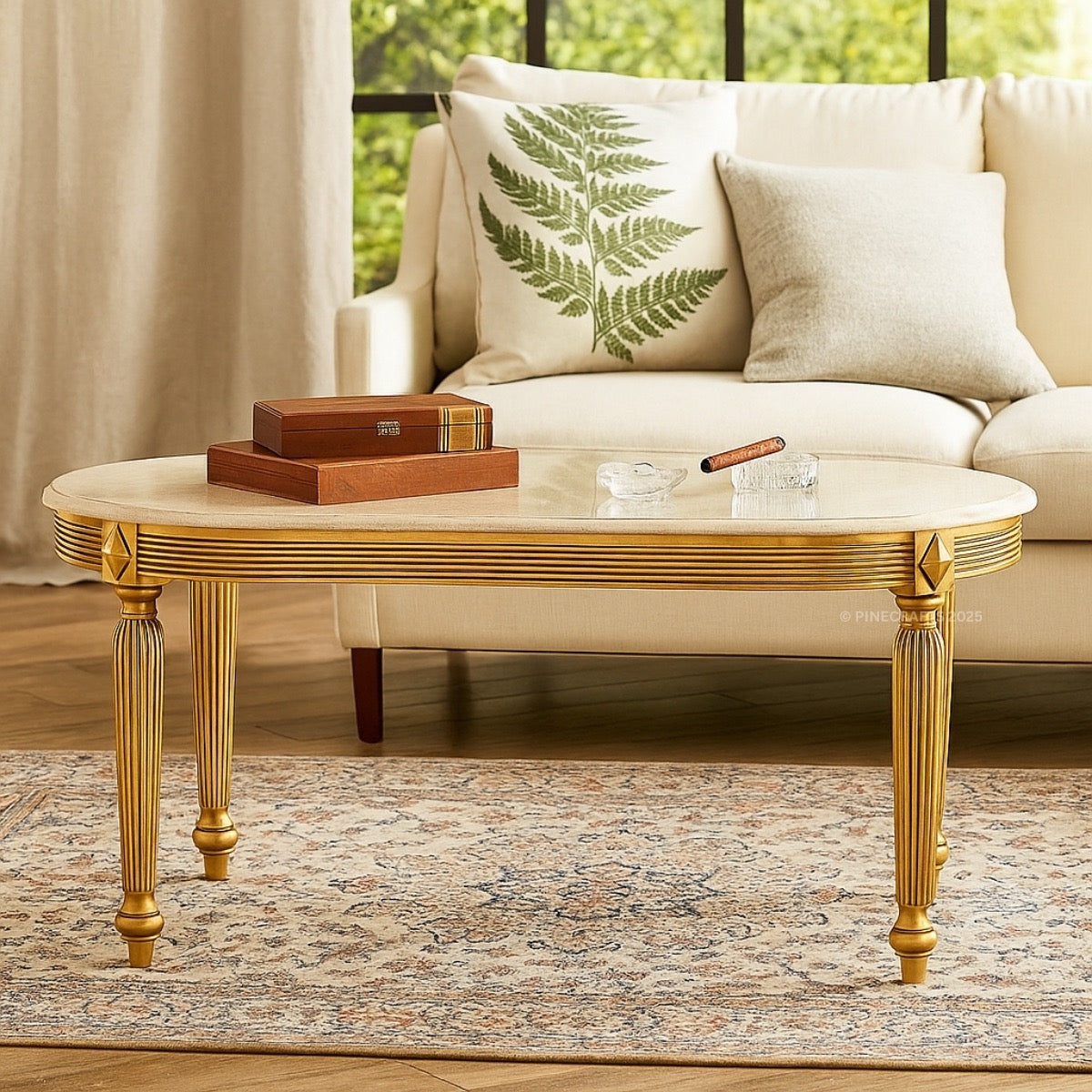 Gold coffee table with decorative items in front of a beige sofa with patterned cushions.