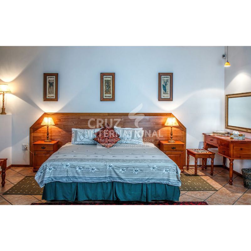 Wooden double bed with bedside tables, lamps, and vanity in a cozy modern bedroom