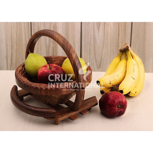 Wooden fruit basket with apples, pears, bananas on table at CRUZ INTERNATIONAL furniture store