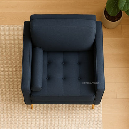 Blue armchair on a wooden floor with a plant in the corner
