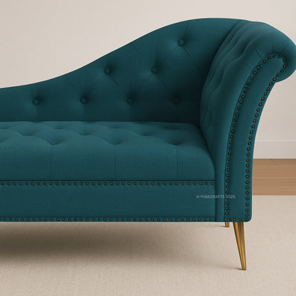 Teal tufted sofa with nailhead trim on a beige background