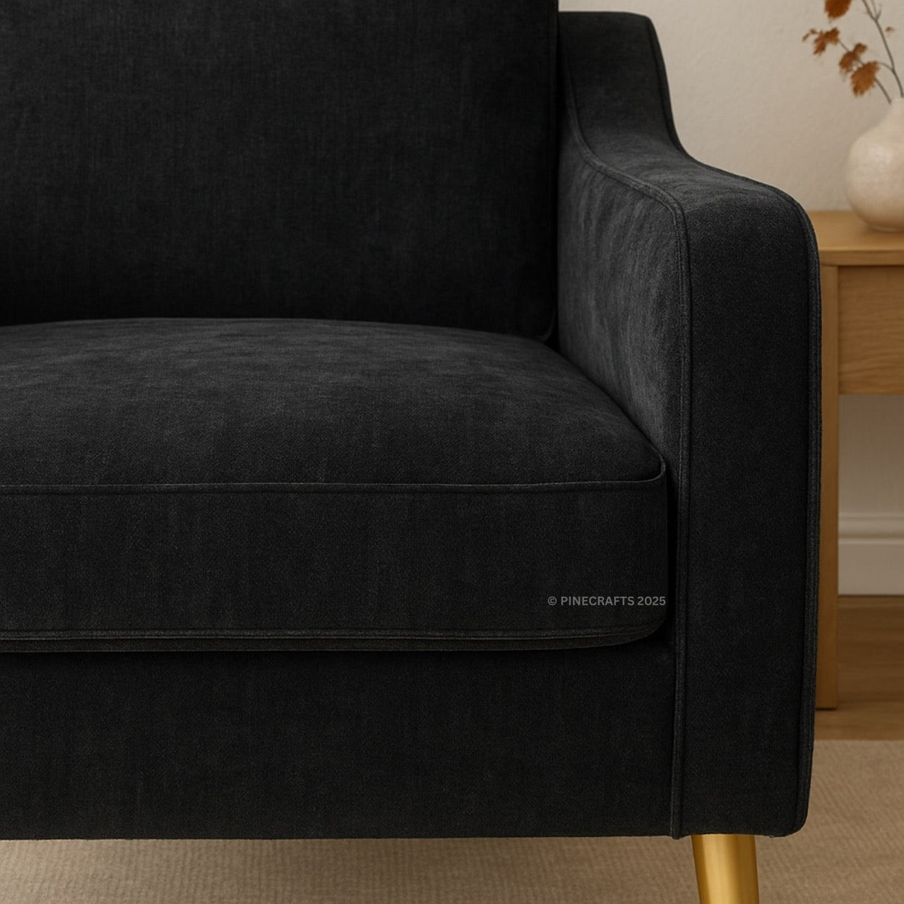 Black sofa with gold legs in a room setting
