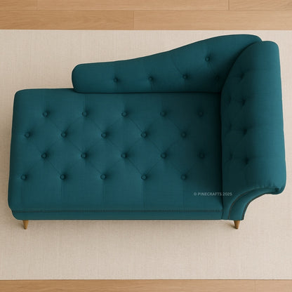 Teal tufted sofa on a beige carpet with wooden floor.