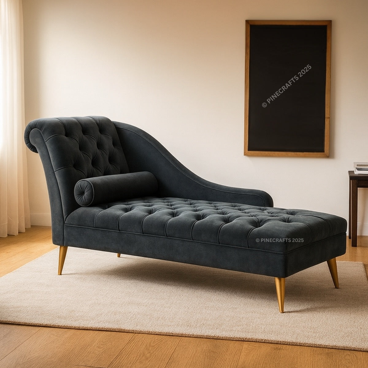 Dark gray tufted chaise lounge in a room with a framed picture on the wall.