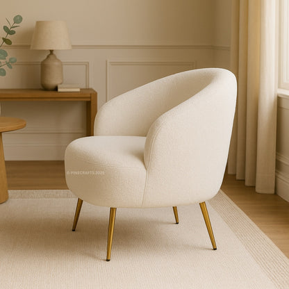Beige armchair with gold legs in a room with wooden furniture and decor.