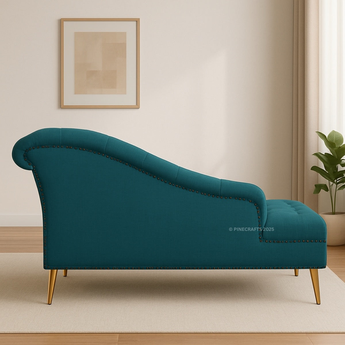 Teal chaise lounge in a room with a plant and framed picture on the wall.