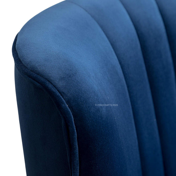 Close-up of a blue upholstered chair with a visible brand logo.