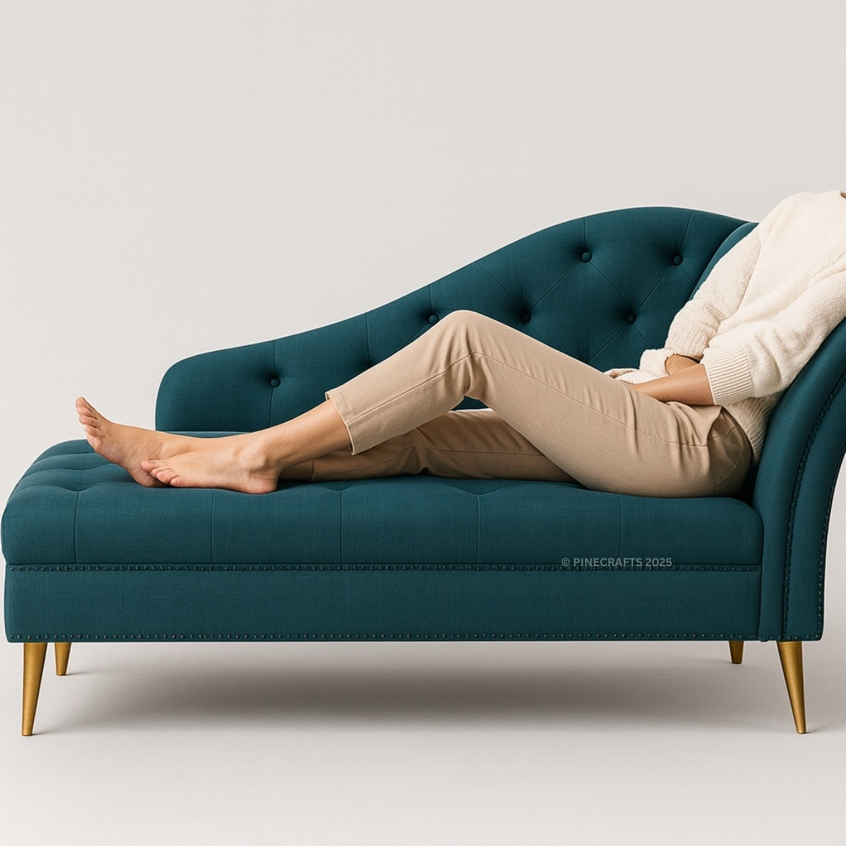 Person relaxing on a teal chaise lounge with gold legs against a light gray background