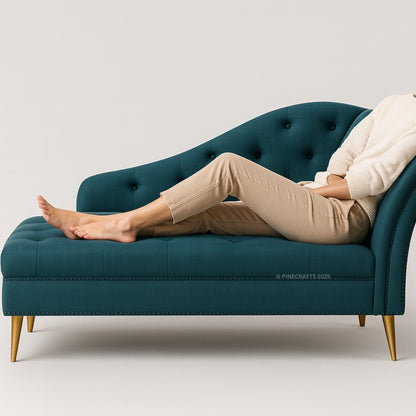 Person relaxing on a teal chaise lounge with gold legs against a light gray background