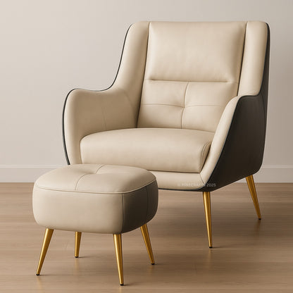 Beige armchair with gold legs and matching ottoman on a wooden floor.