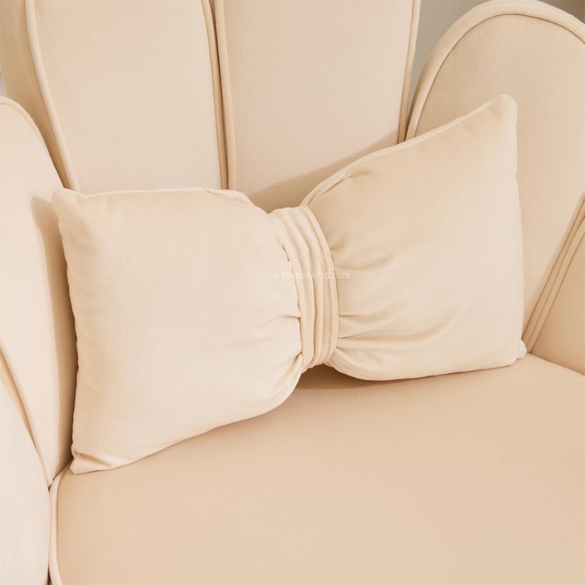 Beige chair with a large bow detail on the backrest