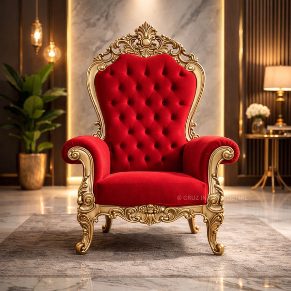 Red velvet throne chair with gold accents in a luxurious room.