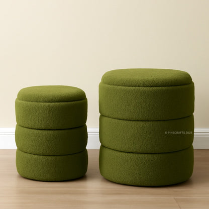 Two green ottomans stacked on top of each other against a beige wall.