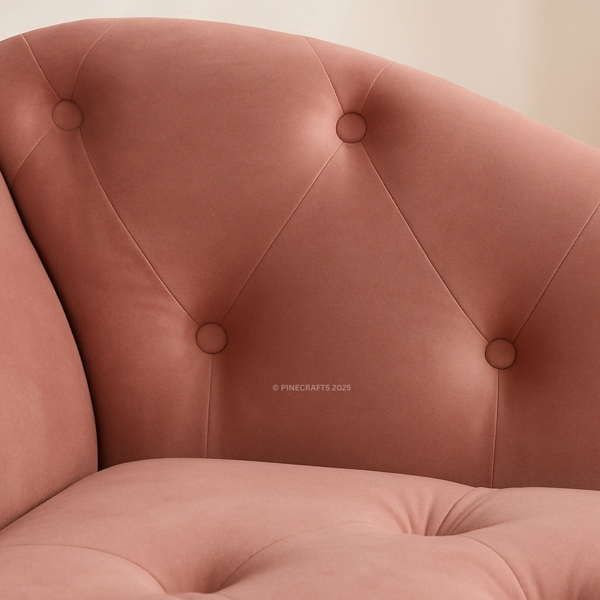 Close-up of a pink tufted chair with a blurred background
