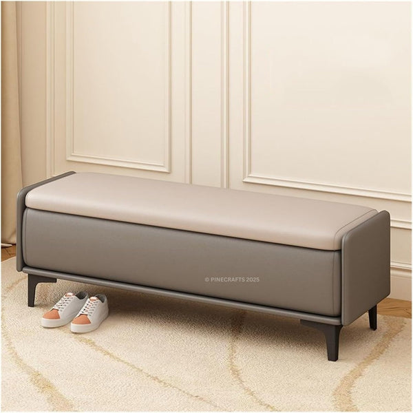 Gray and beige storage bench in a room with white paneled walls and a rug.