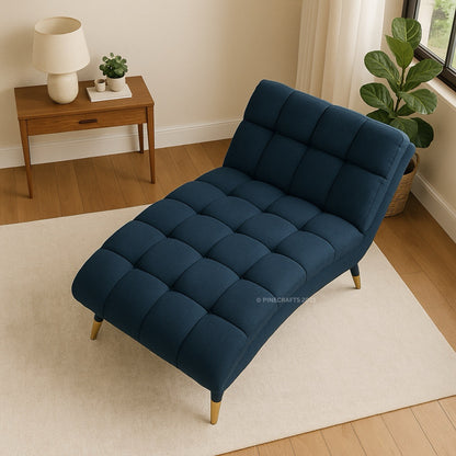 Navy blue tufted sofa bed in a room with a wooden side table and plants.