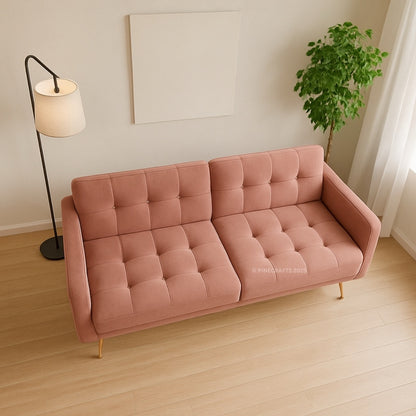 Pink sofa in a room with a lamp and plant