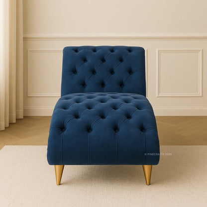 Blue tufted chair with gold legs on a beige carpet in a room with white walls and wooden floor.
