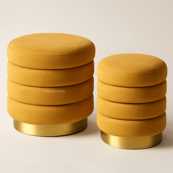Two mustard yellow stools with gold bases on a beige background