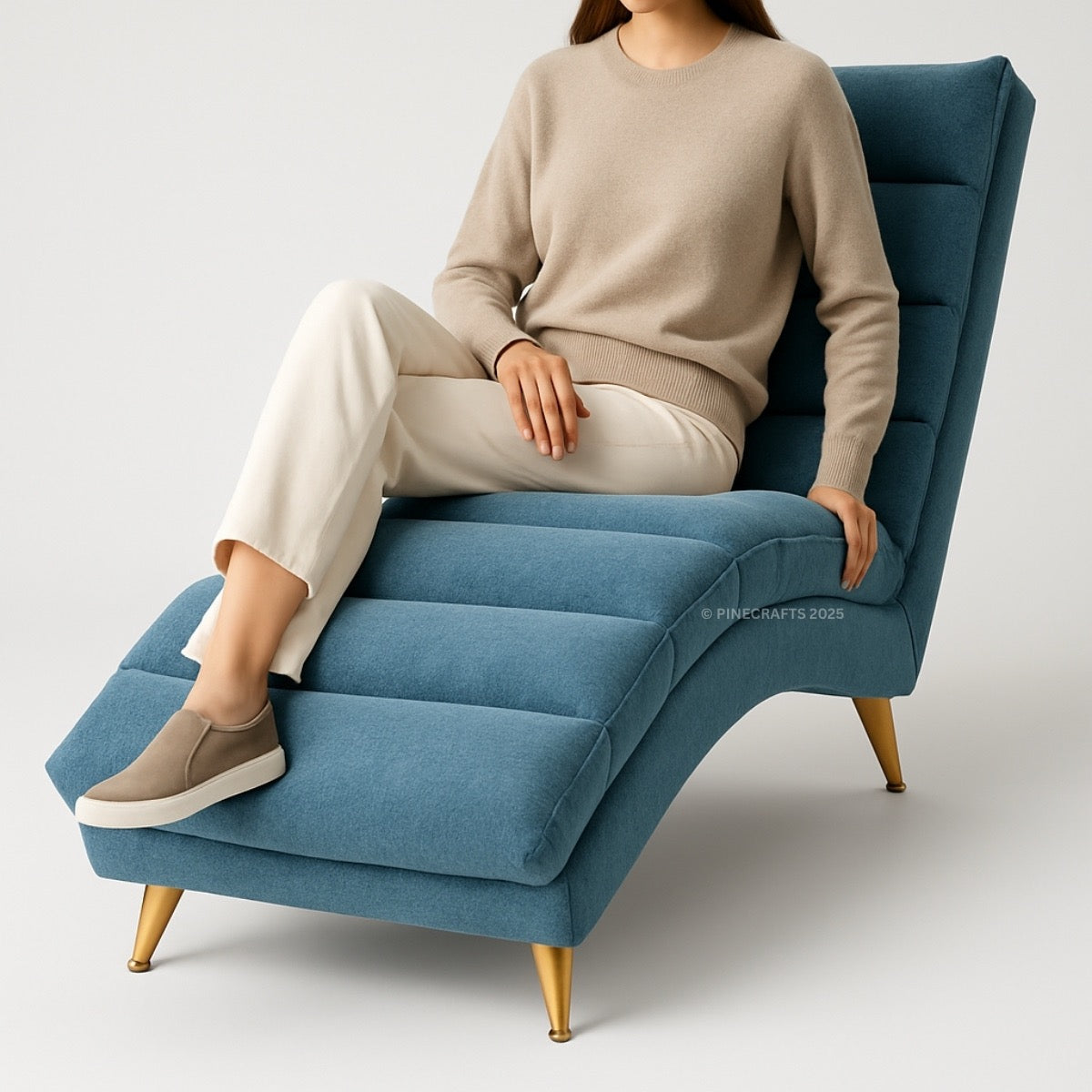 Person sitting on a blue armchair with gold legs against a white background