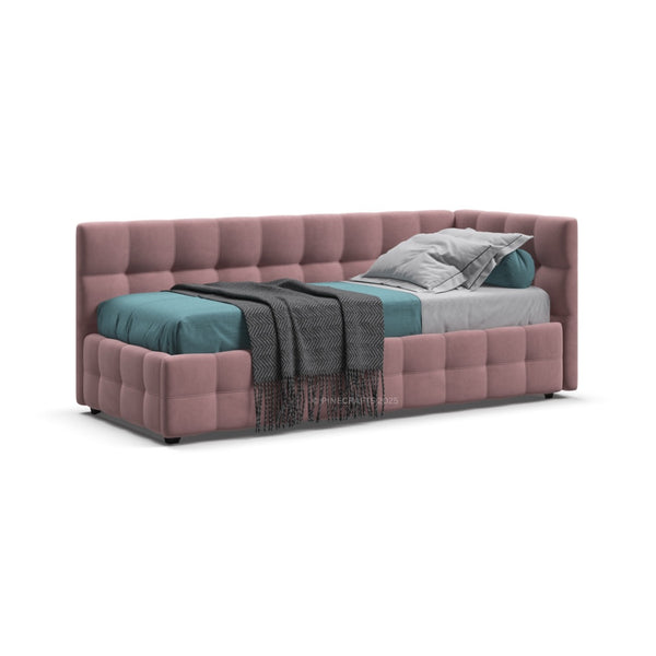 Pink upholstered bed with colorful bedding on a white background