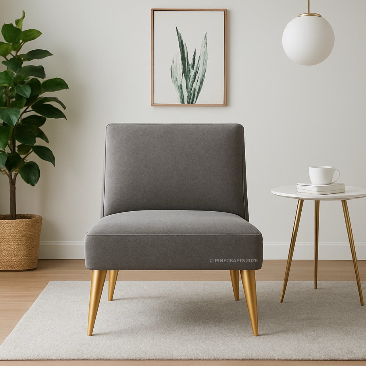 Gray chair with gold legs in a room with a plant, table, and artwork.