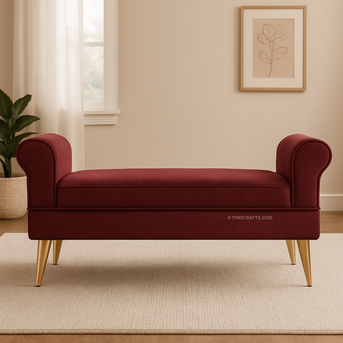 Red bench with gold legs in a room with a plant and framed picture on the wall.