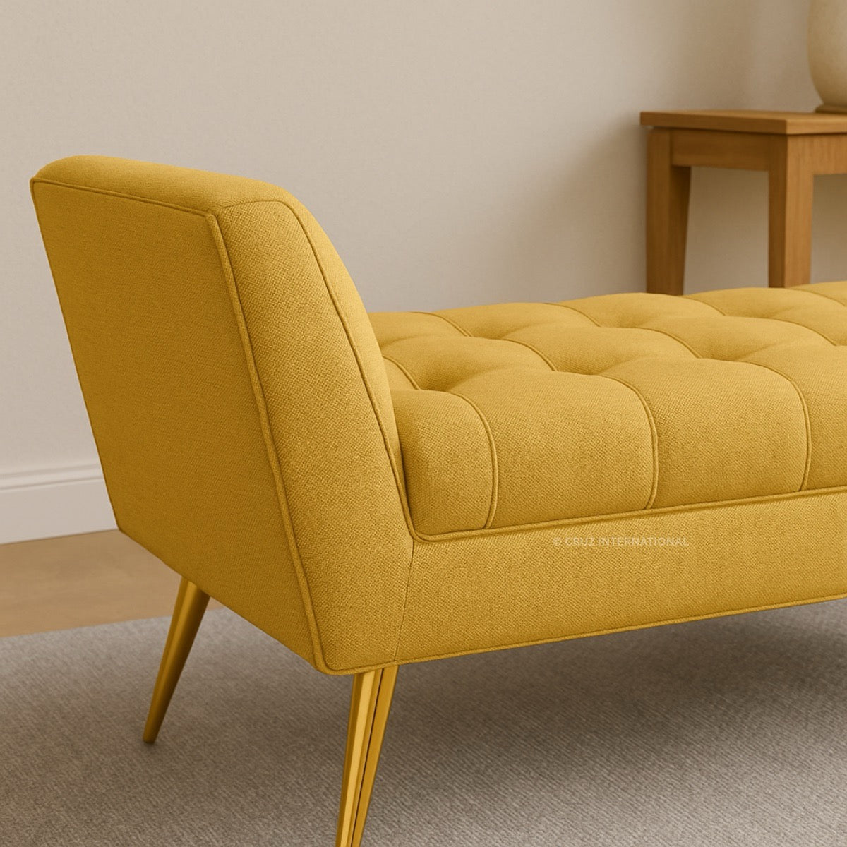 Yellow tufted bench in a room with a wooden table.