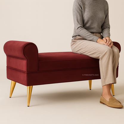 Person sitting on a red bench with gold legs against a beige background