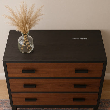 Wooden dresser with a vase of dried plants on top, branded 'Pinecrafts' in the corner.