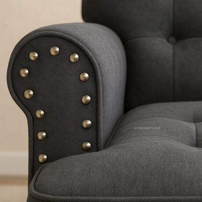 Gray armchair with studded detailing on a beige background