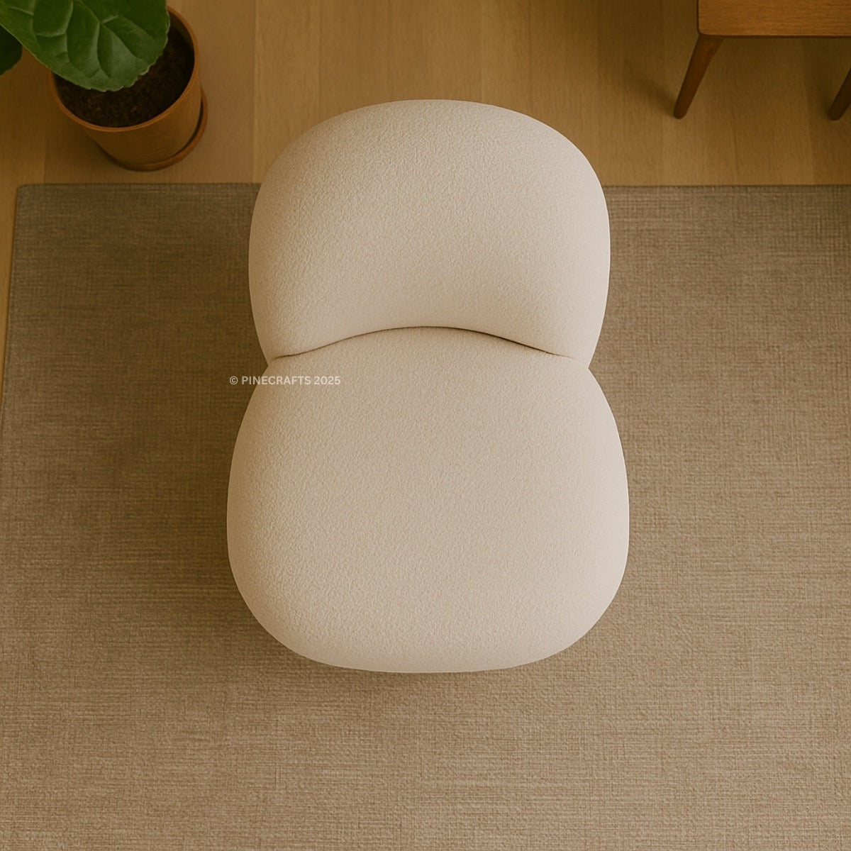 Beige cushion on a textured floor with a plant in the corner
