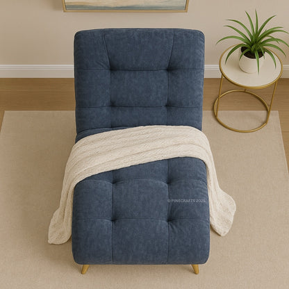 Blue upholstered chair with a white blanket in a room setting