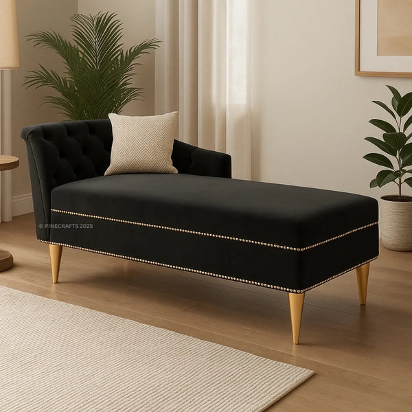 Black tufted bench with gold accents in a room with plants and curtains