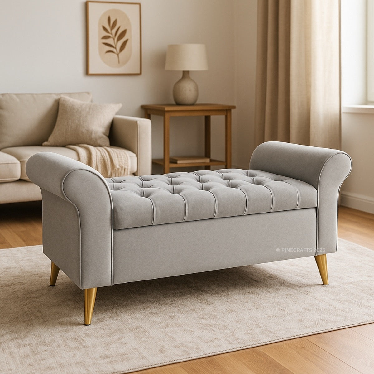 Gray tufted bench in a living room setting with a couch and lamp in the background.