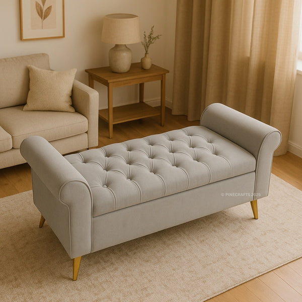Gray tufted bench in a living room setting with beige sofa and wooden side table.