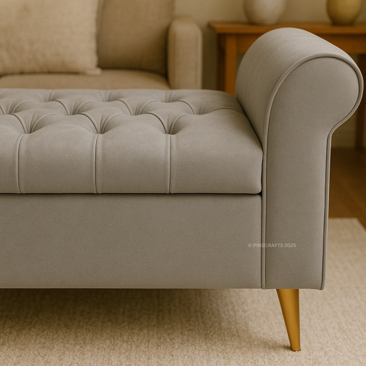 Gray tufted sofa with gold legs in a room setting
