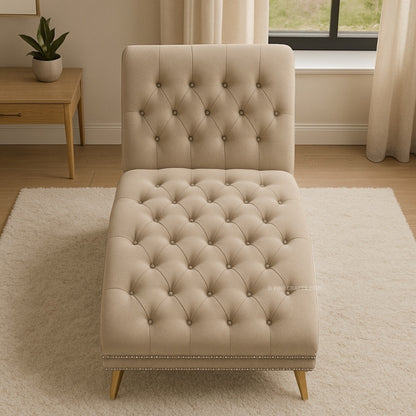 Beige tufted chair in a room with a wooden table and curtains.