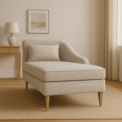 Beige armchair in a room with a lamp and framed picture on the wall.