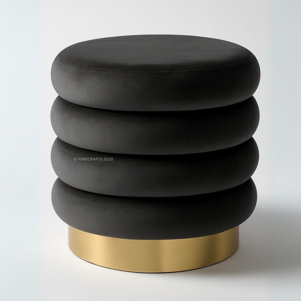 Black ottoman with gold base on a white background