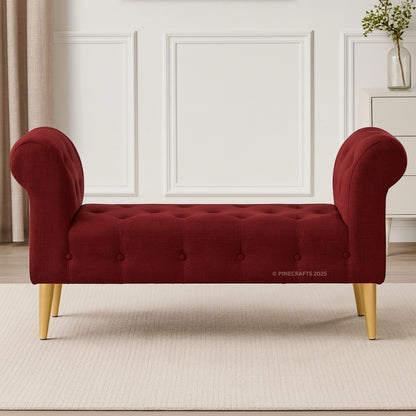 Red tufted bench with gold legs in a room setting