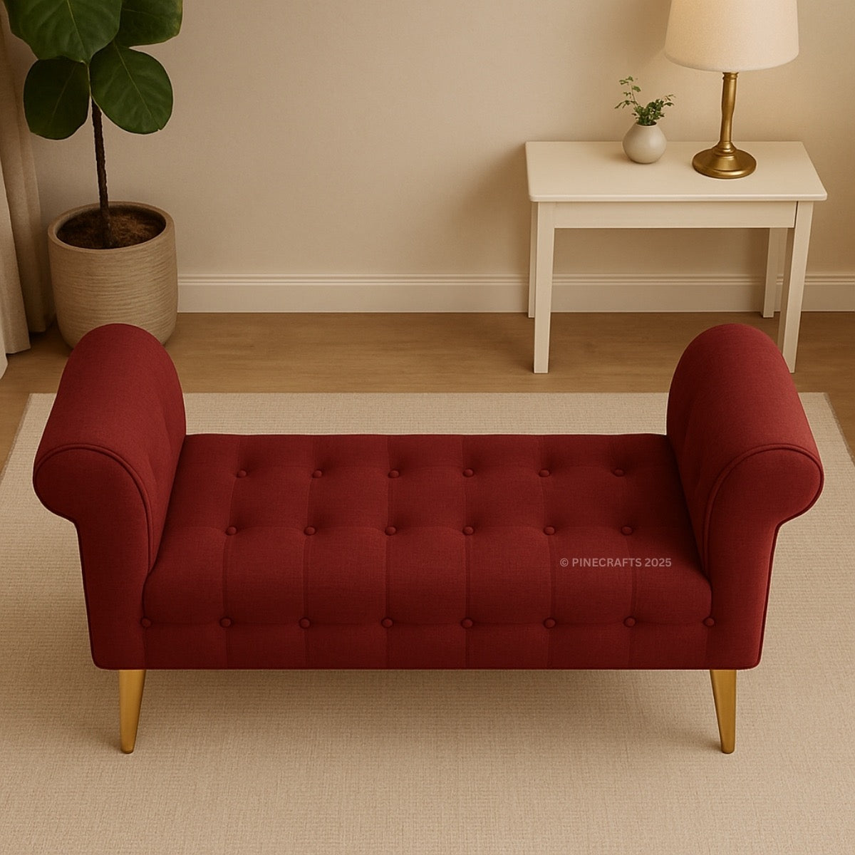 Red tufted bench in a room with a white table and lamp.