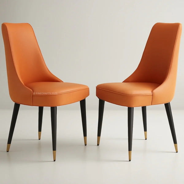 Two orange chairs with black legs on a light gray background